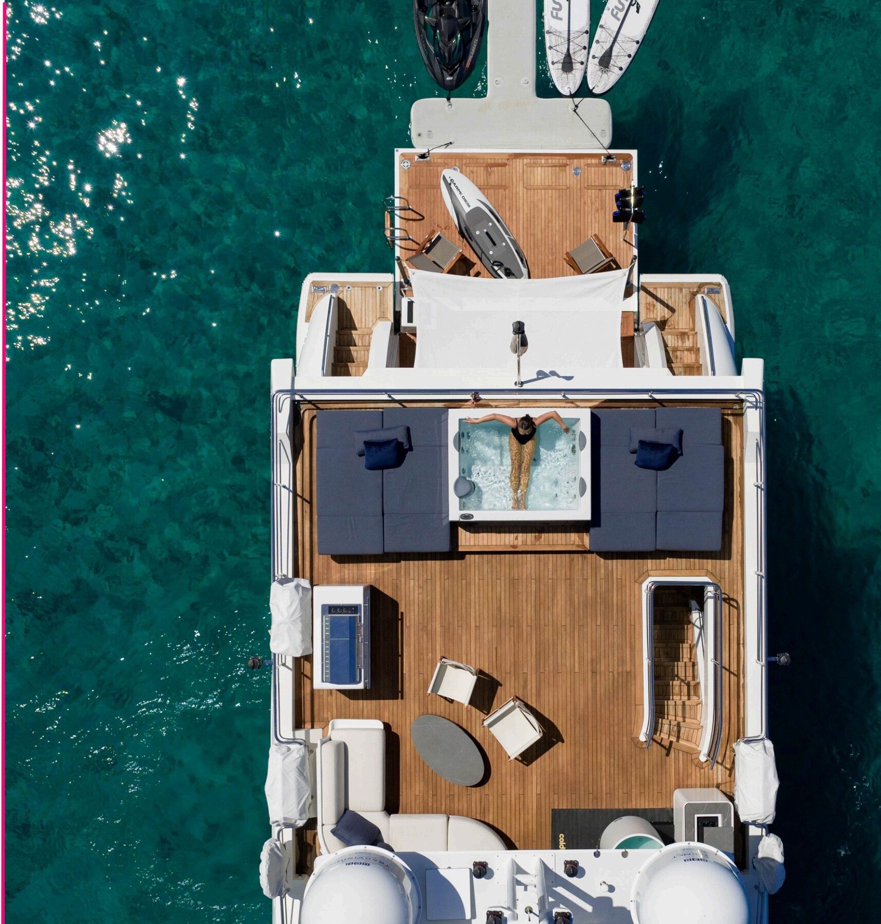Top-down aerial of Carpe Diem with sun deck jacuzzi and tender platform