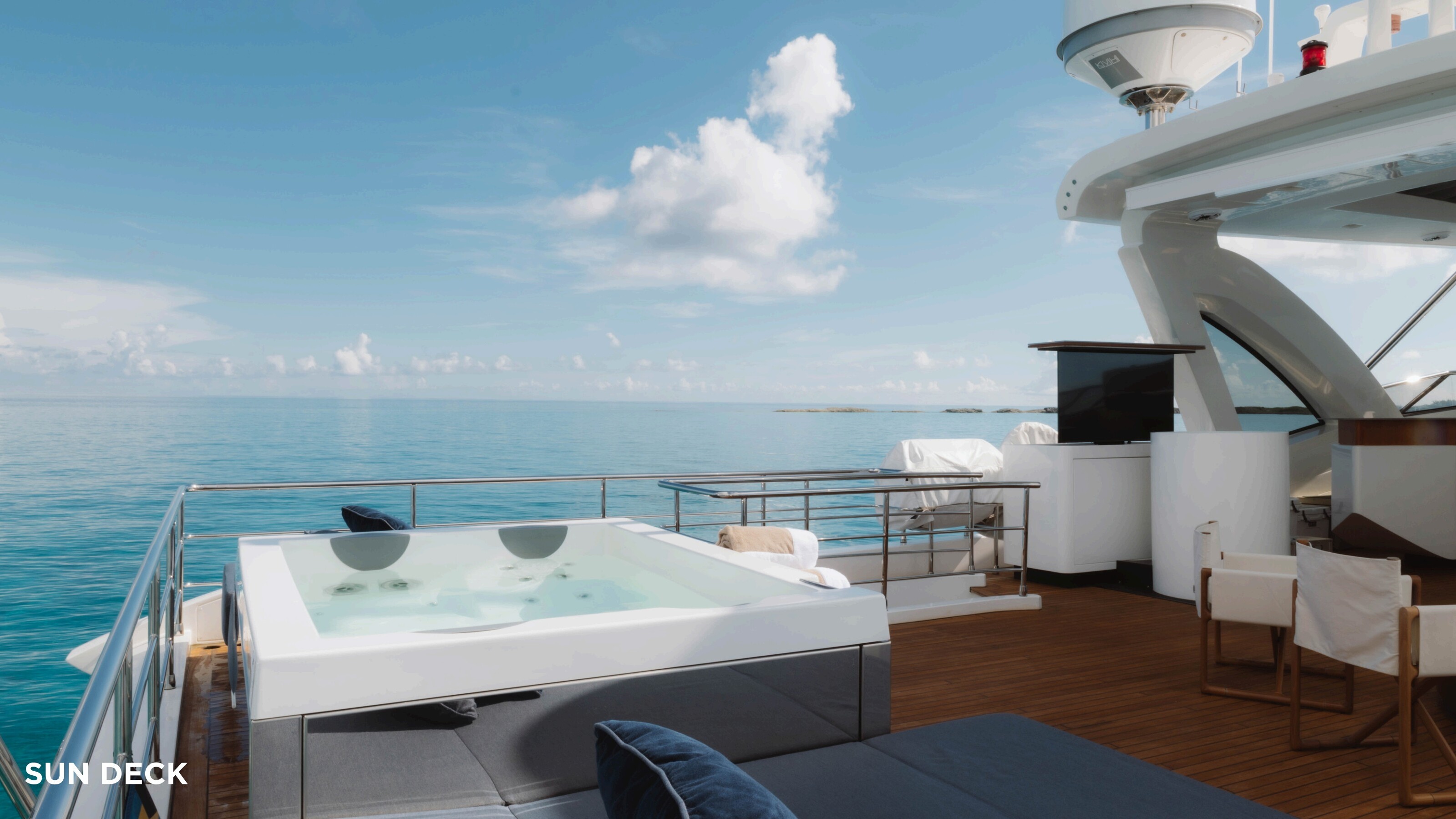Sun deck with jacuzzi and lounge seating